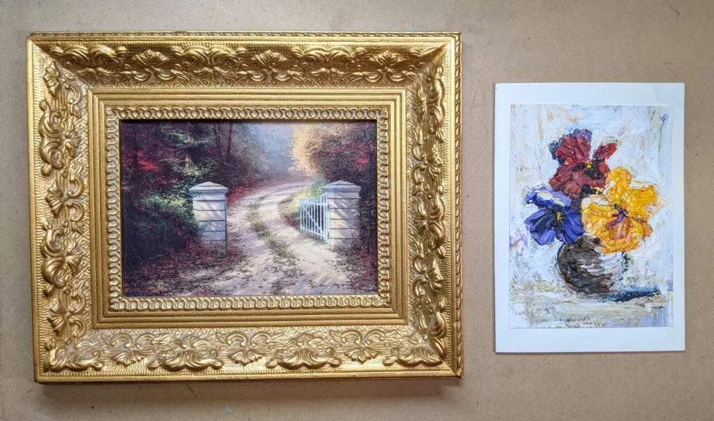 A small gold frame on the left and a greeting card on the right